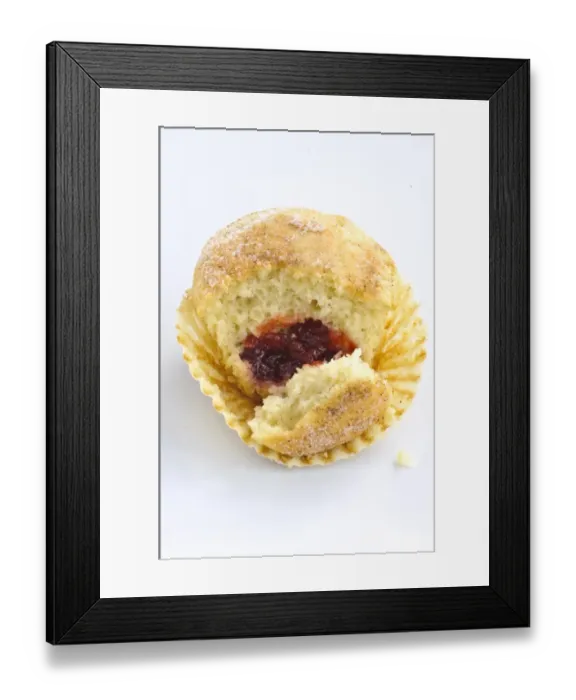 Framed Print : Muffin with sugary top filled with jam (jelly), broken open to show filling. A muffin Framed Print : Muffin with sugary top filled with jam (jelly), broken open to show filling. A muffin