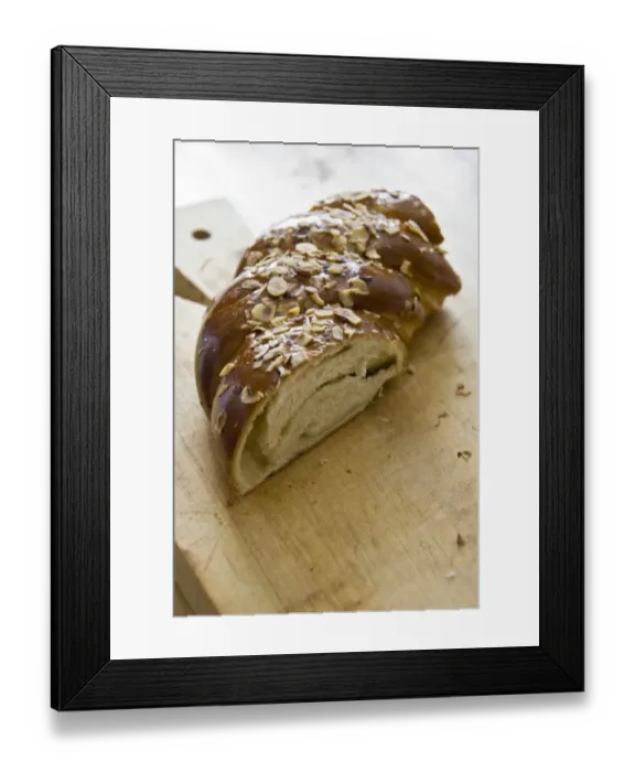 Framed Print : Piece of sweet, yeast bread with almonds and almond paste on wooden board credit Framed Print : Piece of sweet, yeast bread with almonds and almond paste on wooden board credit