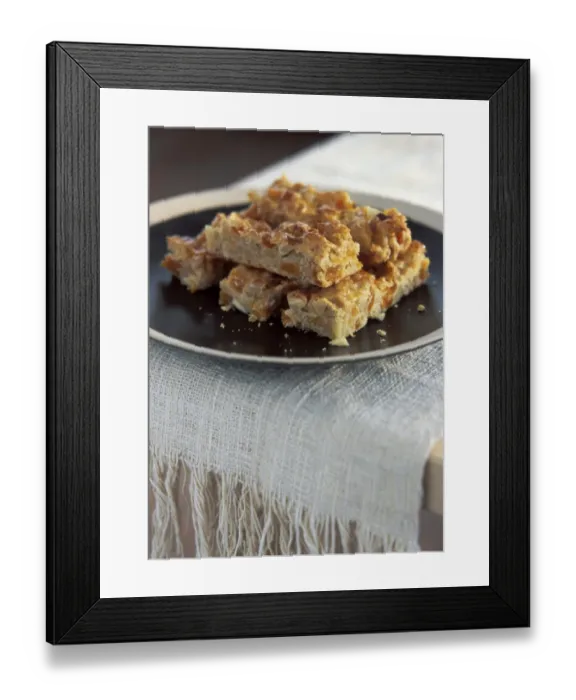 Framed Print : Homemade flapjack cookie bars arranged on brown plate credit: Marie-Louise Avery Framed Print : Homemade flapjack cookie bars arranged on brown plate credit: Marie-Louise Avery