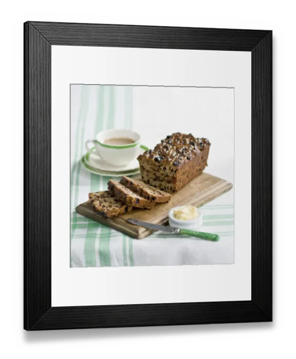 Framed Print : Traditional style fruit tea loaf sliced and served with butter and afternoon tea credit Framed Print : Traditional style fruit tea loaf sliced and served with butter and afternoon tea credit