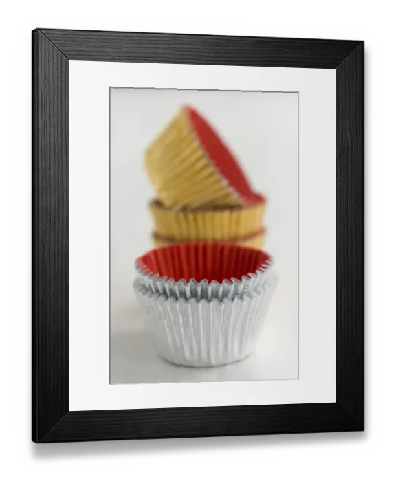 Framed Print : Stack of metallic muffins cases credit: Marie-Louise Avery  /  thePictureKitchen