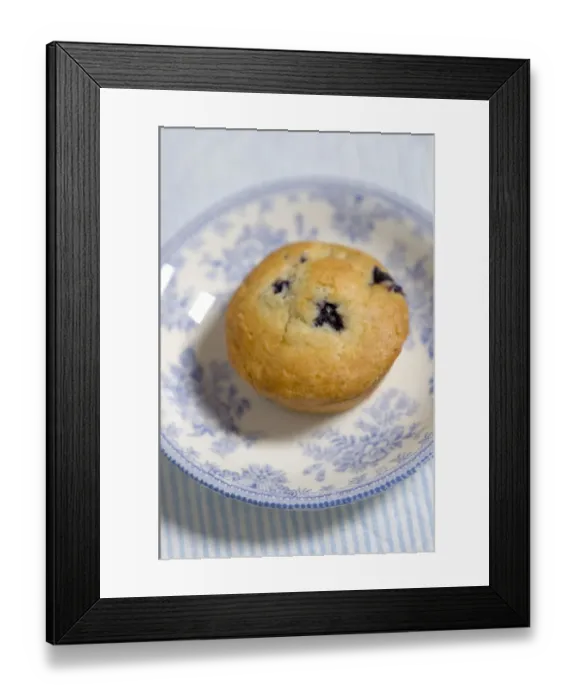 Framed Print : Freshly baked blueberry muffin on blue striped napkin with blue and white china credit Framed Print : Freshly baked blueberry muffin on blue striped napkin with blue and white china credit