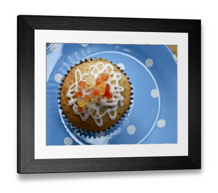 Framed Print : Muffin decorated with squiggly icing and candied peel on spotted blue plate credit Framed Print : Muffin decorated with squiggly icing and candied peel on spotted blue plate credit