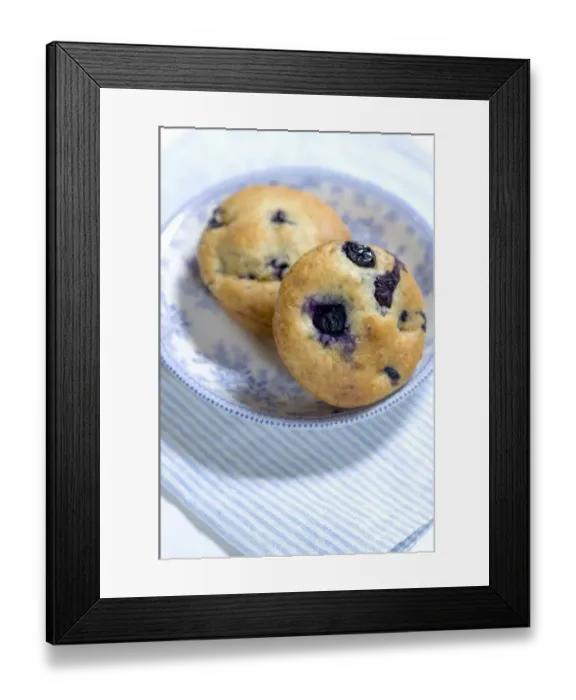 Framed Print : Freshly baked blueberry muffin on blue striped napkin with blue and white china credit Framed Print : Freshly baked blueberry muffin on blue striped napkin with blue and white china credit