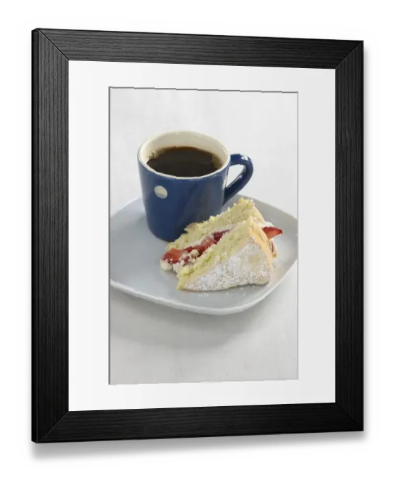 Framed Print : A piece of strawberry sponge cake on a white plate with a small blue and white spotted