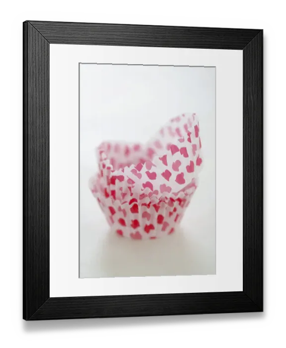 Framed Print : Paper cases for making muffins and fairy cakes - decorated with small red hearts credit