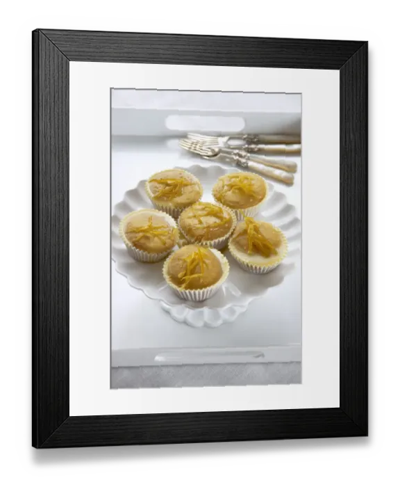Framed Print : Lemon muffins with lemon zest glaze on white cakestand credit: Marie-Louise Avery Framed Print : Lemon muffins with lemon zest glaze on white cakestand credit: Marie-Louise Avery