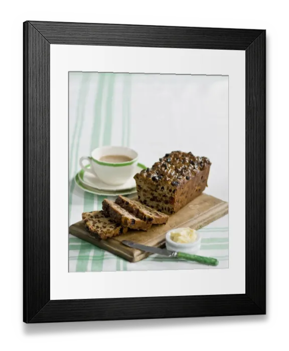 Framed Print : Traditional style fruit tea loaf sliced and served with butter and afternoon tea credit Framed Print : Traditional style fruit tea loaf sliced and served with butter and afternoon tea credit