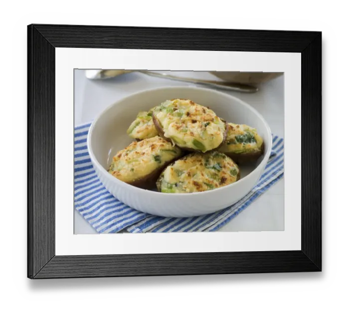 Framed Print : White dish of baked potato halves topped with melted cheese mixture and finished under a hot grill Framed Print : White dish of baked potato halves topped with melted cheese mixture and finished under a hot grill