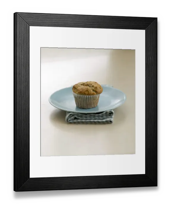 Framed Print : Single poppyseed muffin on blue plate on check napkin, on painted table. credit