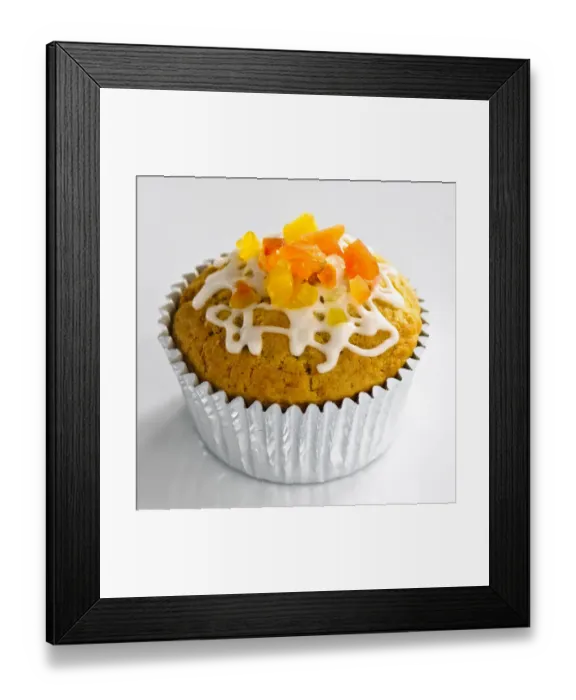 Framed Print : Sweet muffin in foilcase topped with candied fruit and icing trails credit: Marie-Louise Framed Print : Sweet muffin in foilcase topped with candied fruit and icing trails credit: Marie-Louise