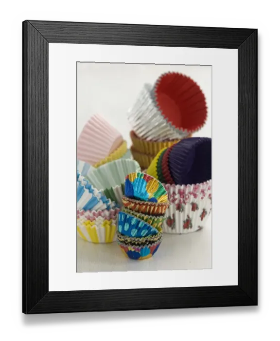 Framed Print : Variety of colourful muffin cases stacked high credit: Marie-Louise Avery  /  thePictureKitchen