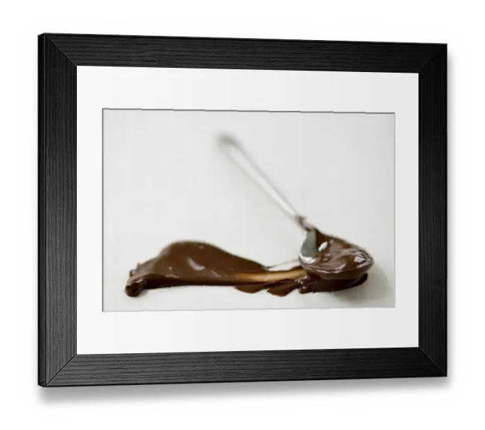 Framed Print : Melted chocolate on teaspoon, with smear of chocolate on greaseproof paper credit