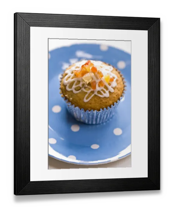 Framed Print : Muffin decorated with squiggly icing and candied peel on spotted blue plate credit Framed Print : Muffin decorated with squiggly icing and candied peel on spotted blue plate credit