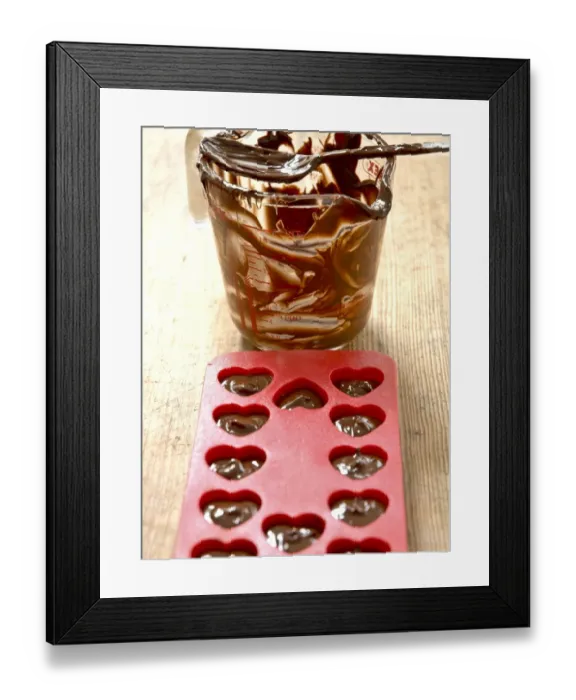 Framed Print : Making heart shaped in chocolates for Valentines day in red heart shaped mould Framed Print : Making heart shaped in chocolates for Valentines day in red heart shaped mould