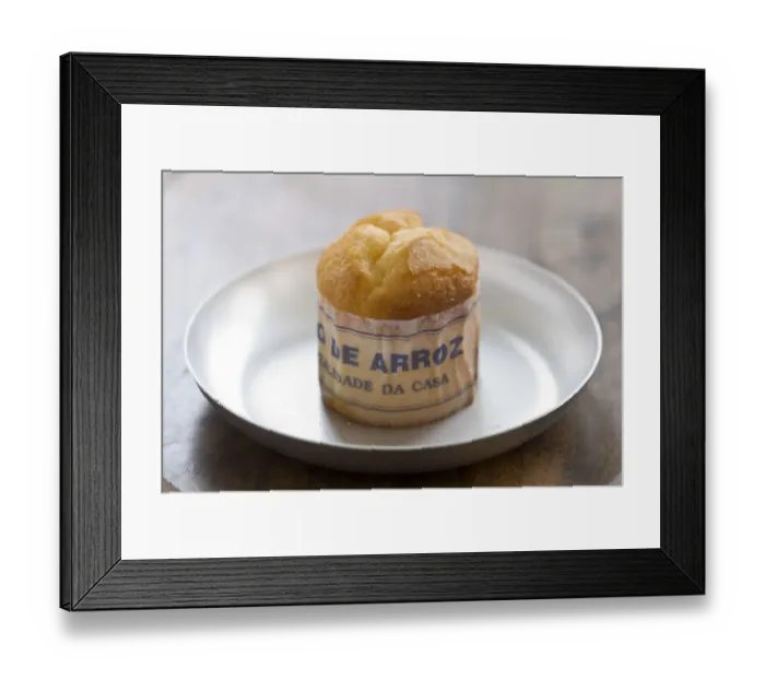 Framed Print : Classic Portuguese muffin type cake made with rice in paper wrapper on metal plate