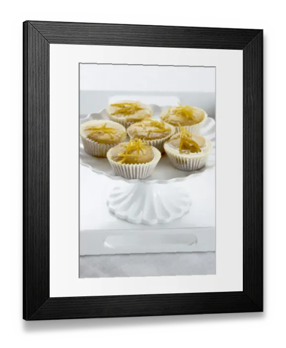 Framed Print : Lemon muffins with lemon zest glaze on white cakestand credit: Marie-Louise Avery Framed Print : Lemon muffins with lemon zest glaze on white cakestand credit: Marie-Louise Avery