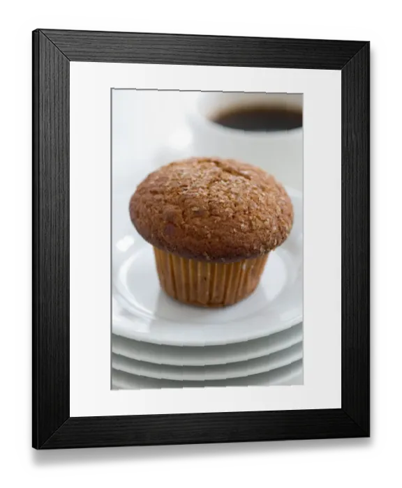 Framed Print : Cinnamon bran muffin on stack of white plates with cup of black coffee credit Framed Print : Cinnamon bran muffin on stack of white plates with cup of black coffee credit