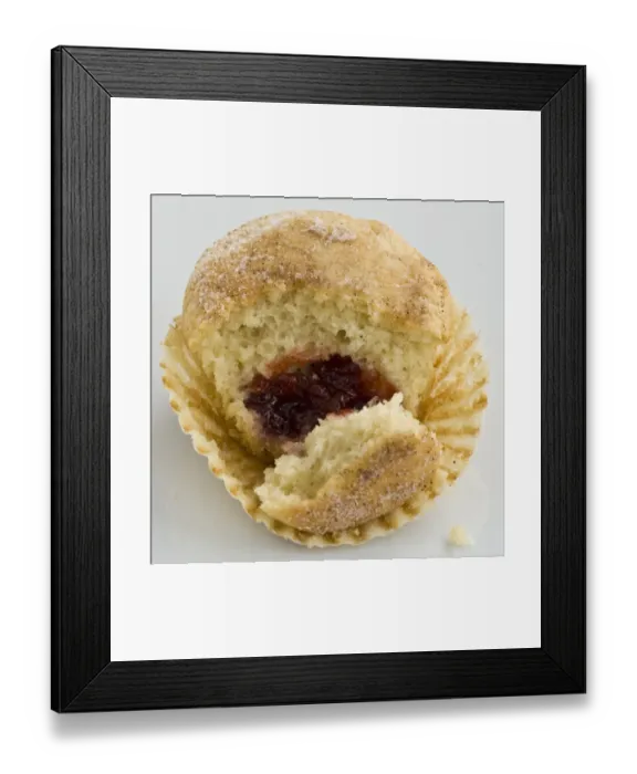 Framed Print : Muffin with sugary top filled with jam (jelly), broken open to show filling. A muffin