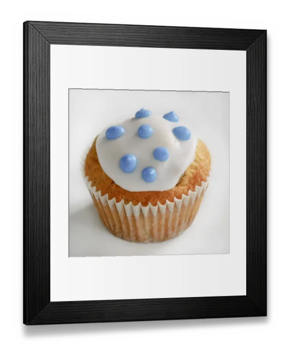 Framed Print : Iced cupcake with blue spots on white icing credit: Marie-Louise Avery  /  thePictureKitchen