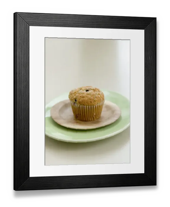 Framed Print : Healthy bran and raisin muffin on small wooden plate on green platter credit: Marie-Louise Framed Print : Healthy bran and raisin muffin on small wooden plate on green platter credit: Marie-Louise