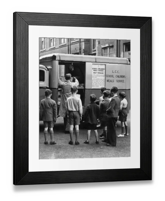 Framed Print : Schoolboys watch one of their meals-on-wheels arriving. Every day in various cooking centres Framed Print : Schoolboys watch one of their meals-on-wheels arriving. Every day in various cooking centres