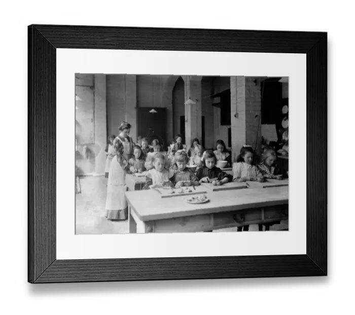 Framed Print : Edwardian school. Young girls, in the classroom, being supervised by their teacher Framed Print : Edwardian school. Young girls, in the classroom, being supervised by their teacher