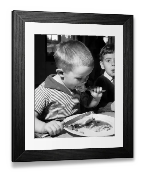 Framed Print : Bobby Mitchell, age 5 during lunch at Melcombe Infants School, Fulham Palace Road, London