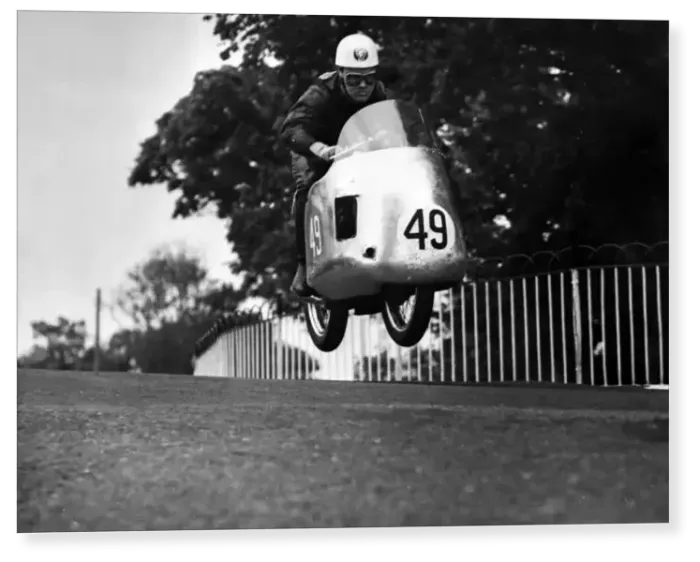 Print : Bob McIntyres Norton takes off as he comes over Ballaugh Bridge during the International Print : Bob McIntyres Norton takes off as he comes over Ballaugh Bridge during the International