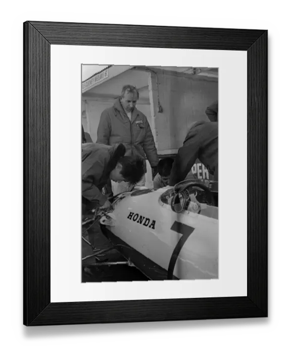 Framed Print : Japanese mechanics working on the suspension of John Surtees Honda car during testing Framed Print : Japanese mechanics working on the suspension of John Surtees Honda car during testing