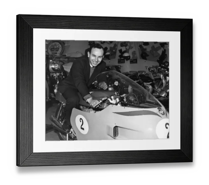 Framed Print : John Surtees sitting astride his racing MV Augusta motorbike inside his family motorcycle