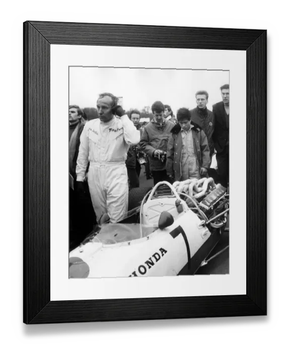 Framed Print : John Surtees leaving his honda after retiring with engine trouble during the Race Framed Print : John Surtees leaving his honda after retiring with engine trouble during the Race