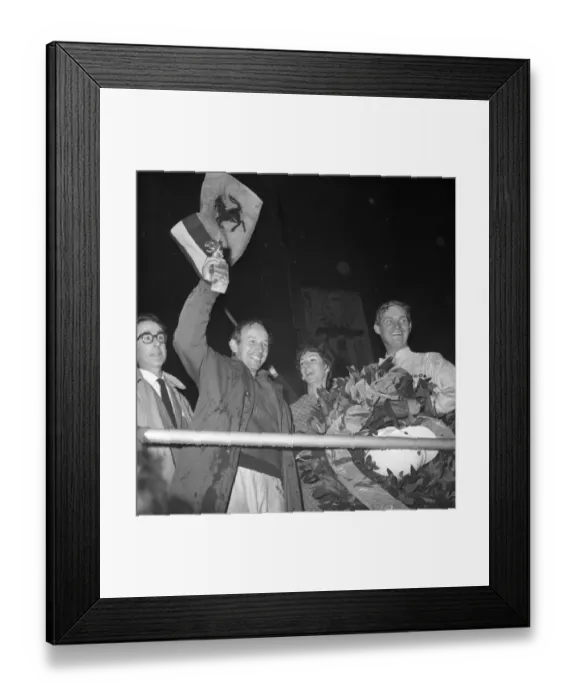 Framed Print : John Surtees smiles as he waves his trophy from the Victory Rostrum after he had