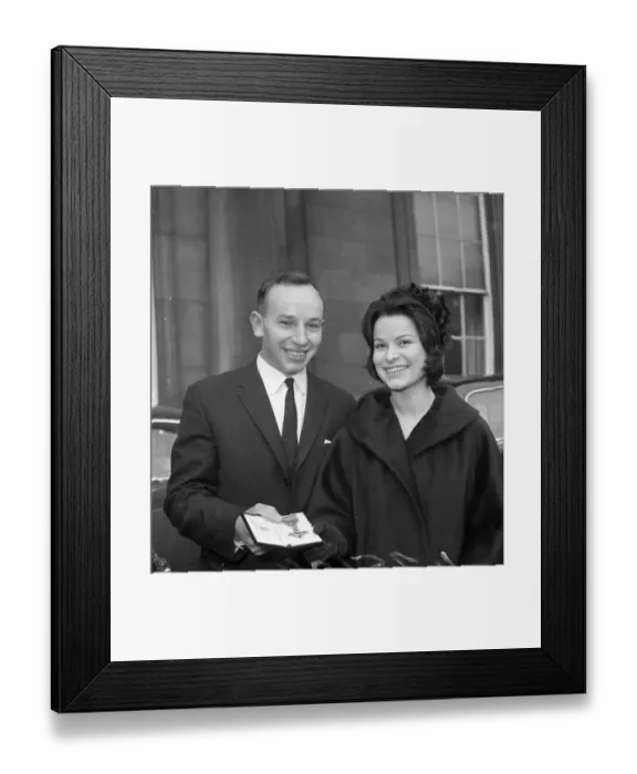 Framed Print : John Surtees with Miss Patricia Burke outside Buckingham Palace after he collected