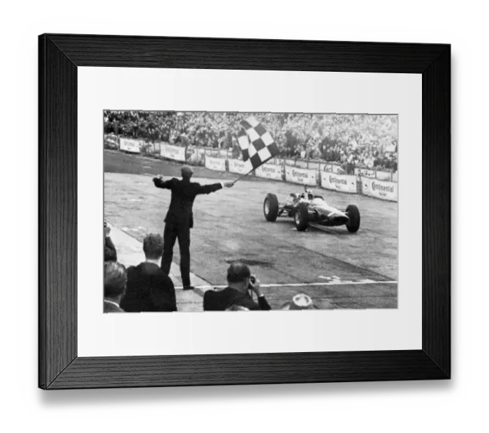 Framed Print : John Surtees roars across the finish line in his Ferrari to win the German Grand Prix at Adenau