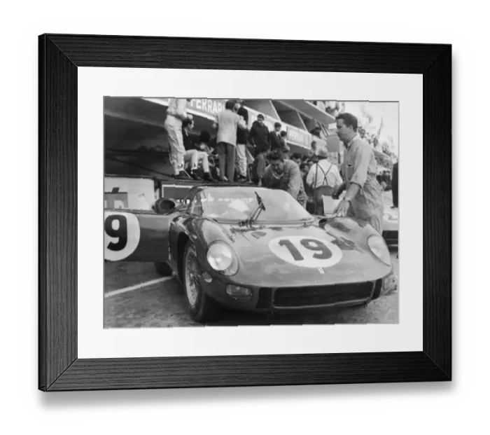 Framed Print : John Surtees bends under the driving wheel of his Ferrari here last night after he Framed Print : John Surtees bends under the driving wheel of his Ferrari here last night after he