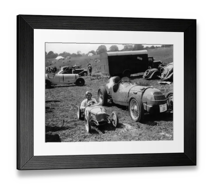 Framed Print : A young boy in his small motorcar