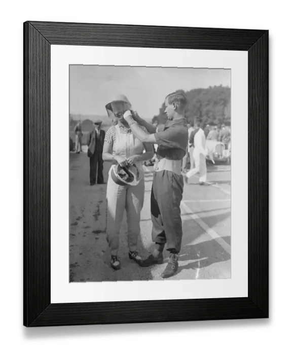 Framed Print : Mr A. C Dobson adjusting his wifes helmet before she took the track in her Fiat Framed Print : Mr A. C Dobson adjusting his wifes helmet before she took the track in her Fiat