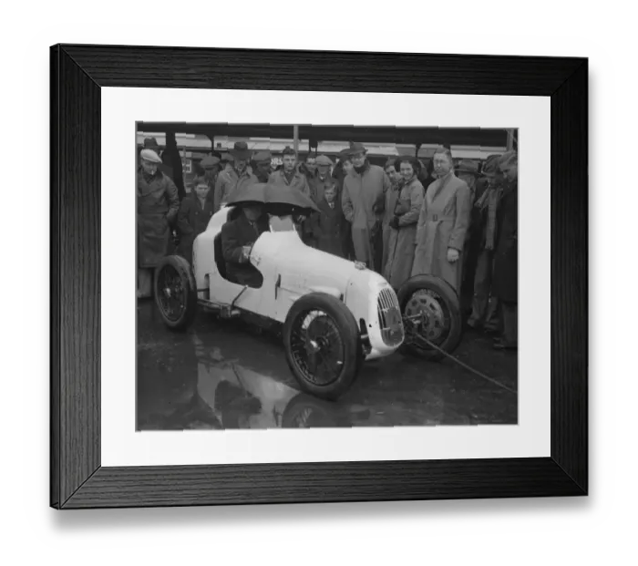Framed Print : Umbrella as hood at rain sodden Brooklands. Heavy rain caused disappointment to Framed Print : Umbrella as hood at rain sodden Brooklands. Heavy rain caused disappointment to