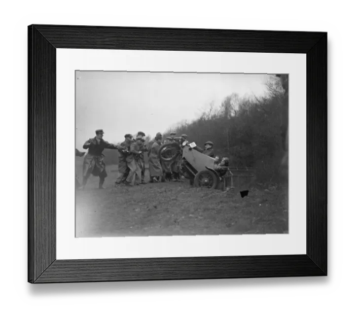Framed Print : A group of men pull a motorbike out of a ditch after it lost control during the race