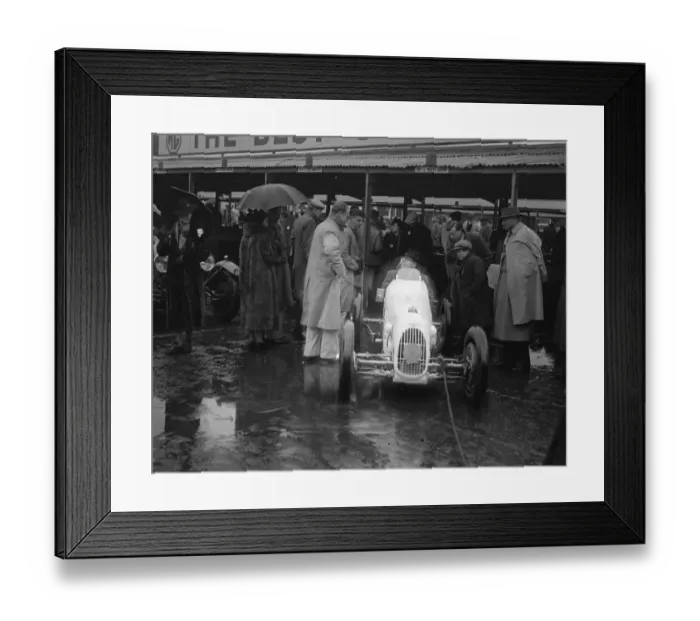 Framed Print : Umbrella as hood at rain sodden Brooklands. Heavy rain caused disappointment to