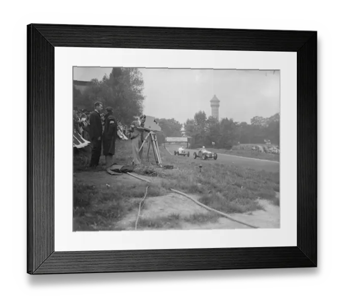 Framed Print : The race being televised in front is count Johnny Lurani the Italian driver in his Maserati