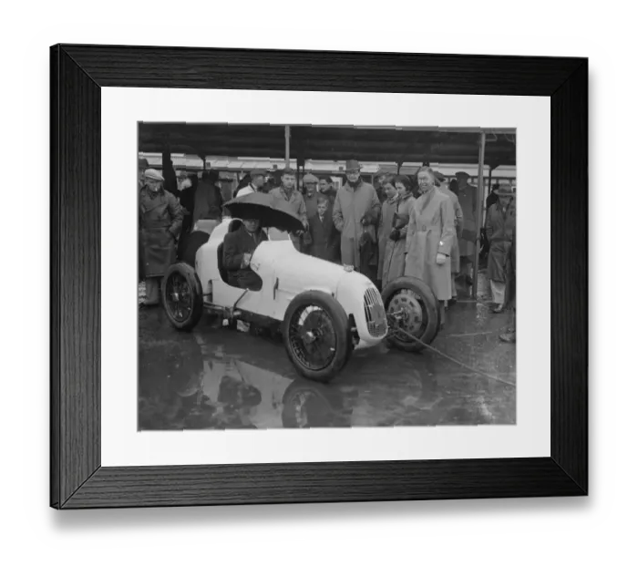Framed Print : Umbrella as hood at rain sodden Brooklands. Heavy rain caused disappointment to Framed Print : Umbrella as hood at rain sodden Brooklands. Heavy rain caused disappointment to