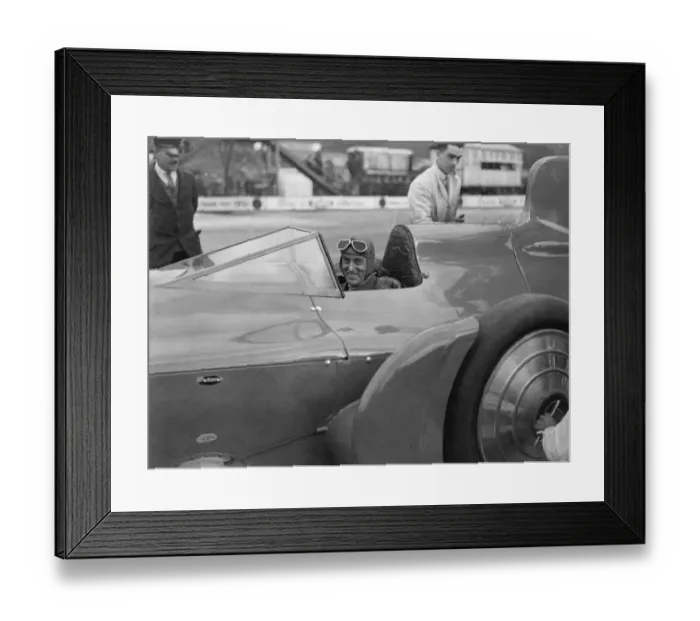 Framed Print : Sir Malcolm Campbell in the cockpit of Bluebird car being rolled out on Easter Monday Framed Print : Sir Malcolm Campbell in the cockpit of Bluebird car being rolled out on Easter Monday