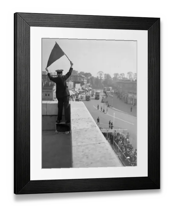 Framed Print : Derby Day, Epsom. A Bus Official controlling the Derby Day buses, taking Framed Print : Derby Day, Epsom. A Bus Official controlling the Derby Day buses, taking