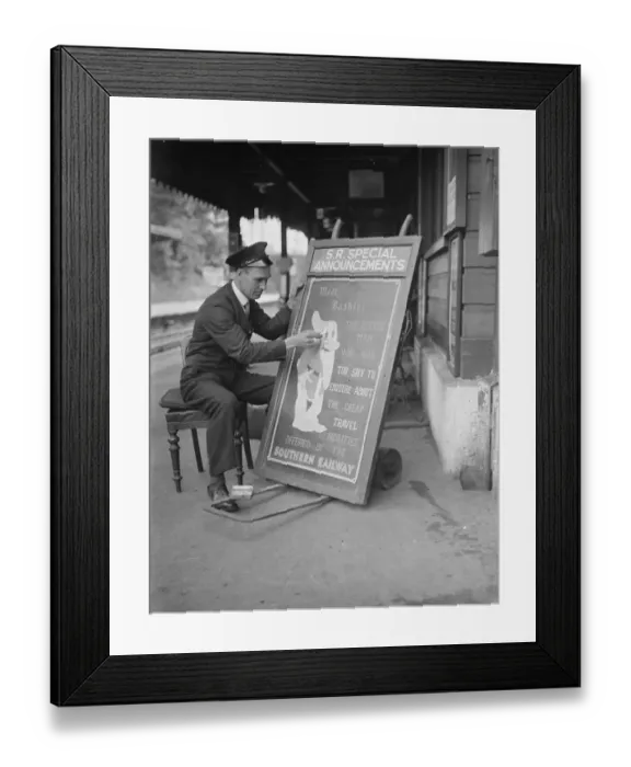 Framed Print : Railway porter sign writer Mr E A Burgar. 1938