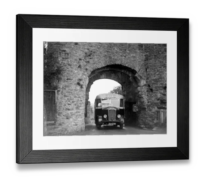 Framed Print : Rye bus passing through arch at Rye Tower in Sussex. 1934