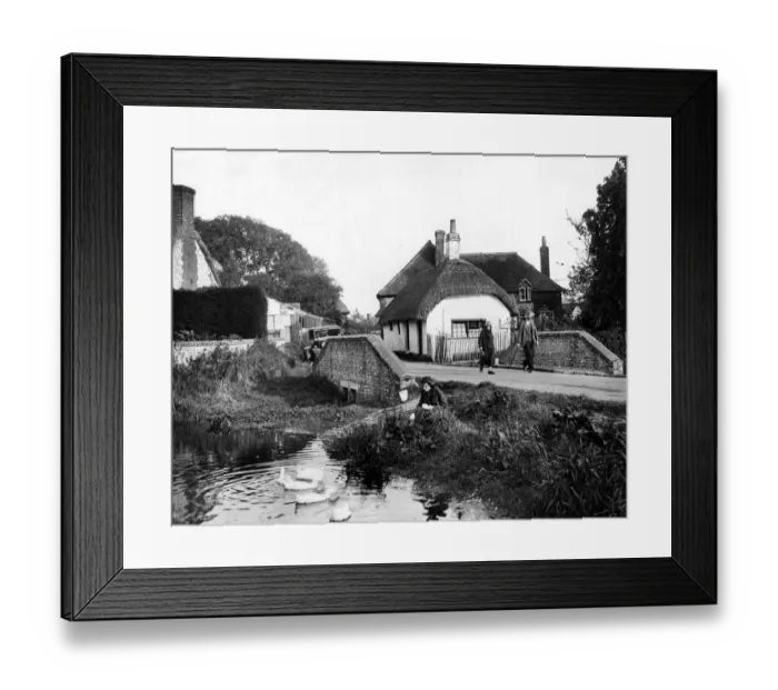 Framed Print : The old thatched cottage, the rippling stream, and a pretty girl feeding the ducks Framed Print : The old thatched cottage, the rippling stream, and a pretty girl feeding the ducks