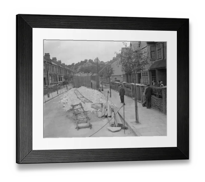 Framed Print : Residents of a street in Plumstead look at what is left of their road following some subsidence