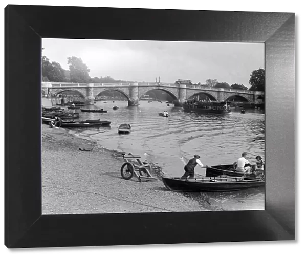 People out enjoying the river Thames at Richmond, London, hiring rowing boats